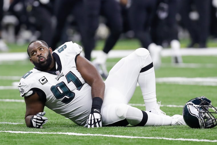 Fletcher Cox lays on the turf after suffering an injury on the Saints' fake-punt play.