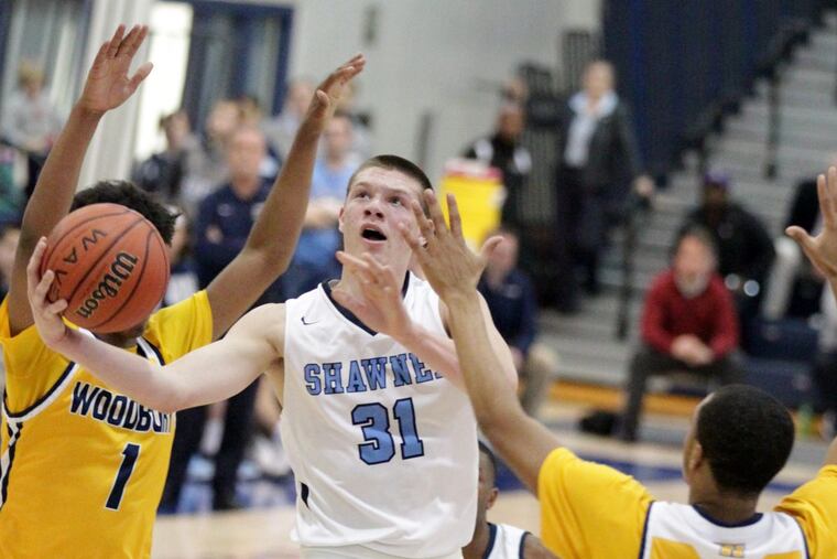 Dean Noll of Shawnee goes past Aaron Estrada, left, and Andre Parker of Woodbury during the Tournament of Championsl at Toms River North.