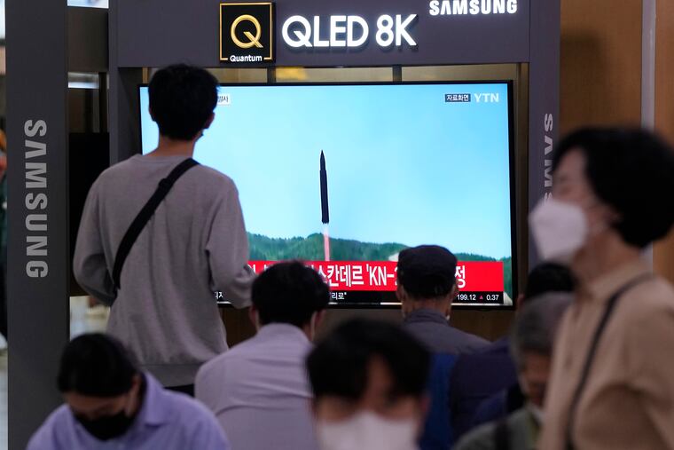A TV screen shows a file image of a North Korean missile launch during a news program at the Seoul Railway Station in Seoul, South Korea, on Wednesday. North Korea fired ballistic missiles toward its eastern waters on Wednesday, South Korea's military said, a day before U.S. Vice President Kamala Harris is to visit the South.