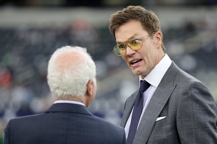 Tom Brady talks with Eagles owner Jeffrey Lurie before broadcasting the Eagles-Cowboys game on Sunday.