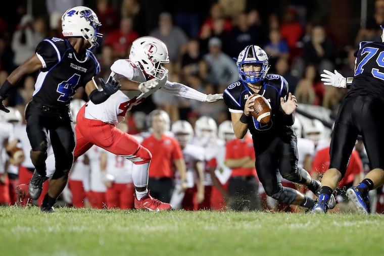 Williamstown quarterback Doug Brown looks to throw the ball to Christian Forman (4) against Lenape in September.