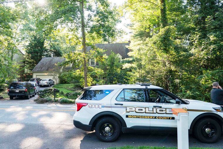 Former National Security Advisor John Bolton's house is seen with a Montgomery County, Md., police vehicle parked outside as FBI agents search the home.