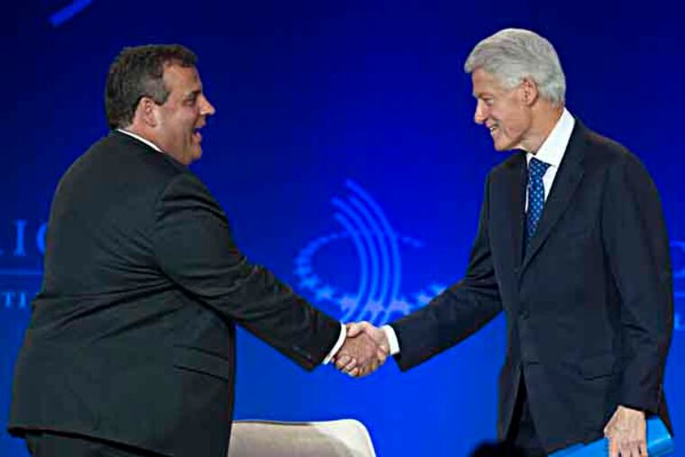 Former President Bill Clinton, right, shakes New Jersey Gov. Chris Christie's hand as he arrives on stage during the Clinton Global Initiative (CGI) Meeting in Chicago, Friday, June 14, 2013. Clinton and Christie spoke during a closing session titled "Cooperation and Collaboration: A Conversation on Leadership." (AP Photo/Scott Eisen)