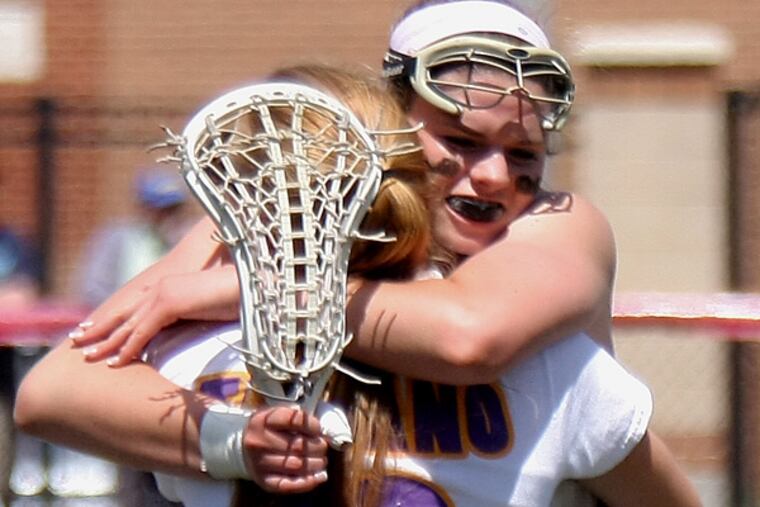 Garnet Valley senior Haley Warden hugs teammate Nova Ward (back to
camera) after the Jaguars defeated Harriton, 16-12, Saturday in a PIAA
state girls’ lacrosse quarterfinal at West Chester East. (Lou Rabito/Staff)