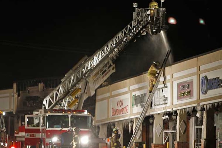 Cheltenham Township and Huntingdon Valley fire departments work to put out a deadly fire in the Melrose Shopping Center along Cheltehman Avenue on Friday morning, Jan. 25, 2013. (Alejandro A. Alvarez / Staff Photographer)