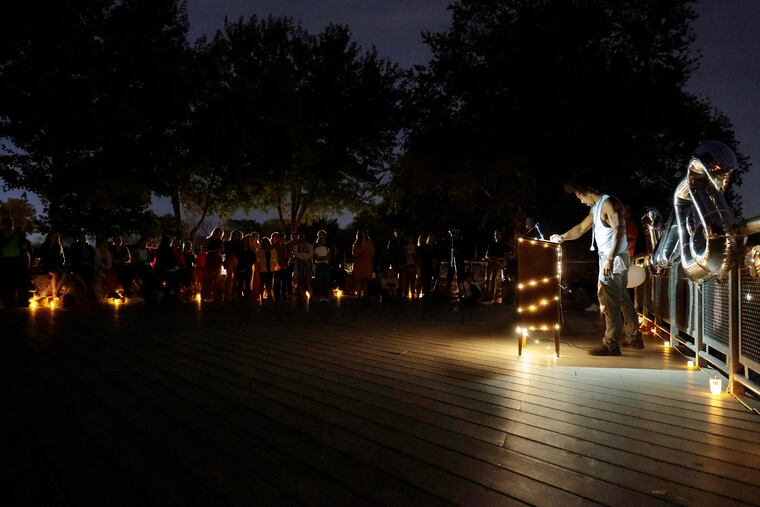 Hunter Gaddy puts the microphone, and his head, down after speaking during a memorial for his brother James Gaddy at Cooper River Park in Cherry Hill, N.J. on Oct. 2. James Gaddy, the leader of a youth yoga and meditation program called Project Little Warriors, died Aug. 29 while on vacation in South Carolina. He lived in Oaklyn.