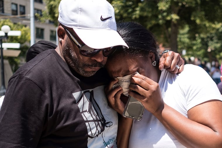 A couple mourn at a vigil held in honour of those who lost their lives during a shooting in Dayton, Ohio, on Sunday, Aug. 4, 2019. Nine people were killed in a mass shooting early Sunday in Dayton, police said, adding that the assailant was shot dead by responding officers. (Megan Jelinger/AFP/Getty Images/TNS)