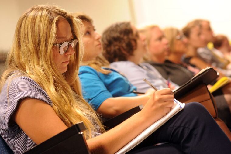 Sara Thornton, who is a learning support instructor, takes notes during a suicide-prevention presentation for teachers and administrators Monday at Prep Charter School in Philadelphia.
