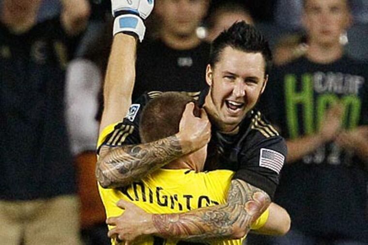Danny Califf and Brad Knighton celebrate after the Union defeated Chicago, 1-0. (AP Photo/Matt Slocum)