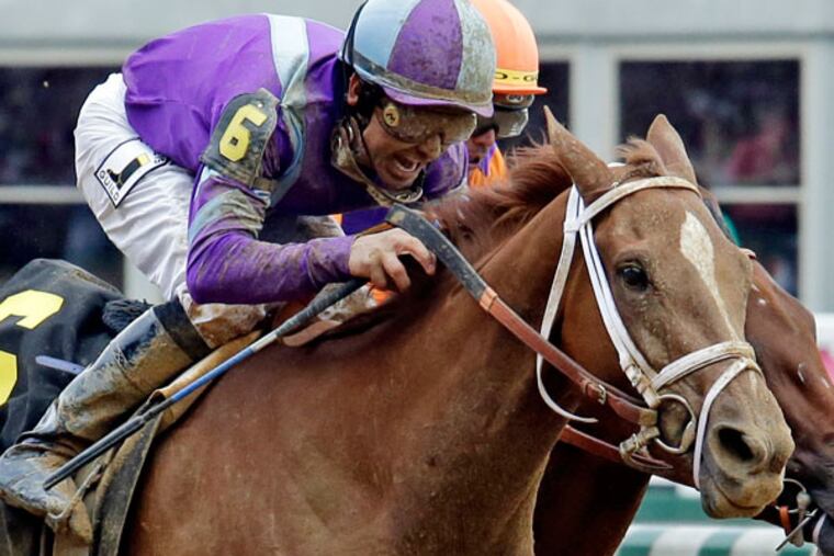 Mike Smith rides Princess of Sylmar to a win over Beholder ridden by Garrett Gomez in the 139th Kentucky Oaks at Churchill Downs in May 2013, in Louisville, Ky. (J. David Ake/AP)