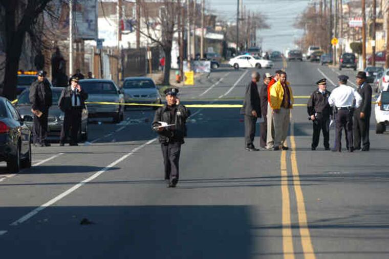 Philadelphia police officers at the scene where a student was shot outside a Feltonville disciplinary school. A 16-year-old 10th-grader was shot after a confrontation with several youths shortly after classes had let out.
