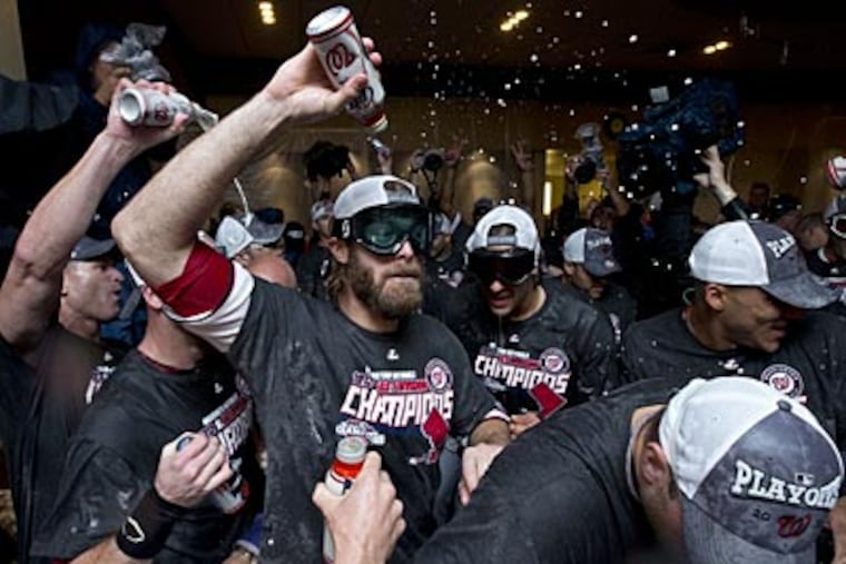Jayson Werth, a former Phillie, celebrates with his Nationals teammates after clinching the NL East title. (Manuel Balce Ceneta/AP)