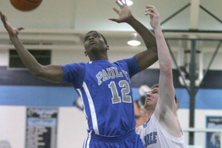 Paul VI's Roosevelt Cubbage (left) pulls down a rebound in front of Shawnee's Dan Kelleher (right). (Charles Fox/Staff Photographer)
