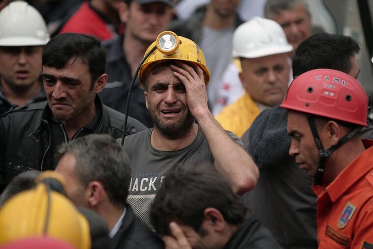 A miner cries as rescue workers carry the dead body of a miner from the mine in Soma, western Turkey, Wednesday, May 14, 2014.(Emrah Gurel / Associated Press)