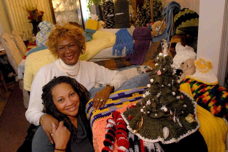 Delorise Easley-Williams with her daughter, Venus M. Jackson, and many of the items she's crocheted, including a Christmas tree in the foreground.