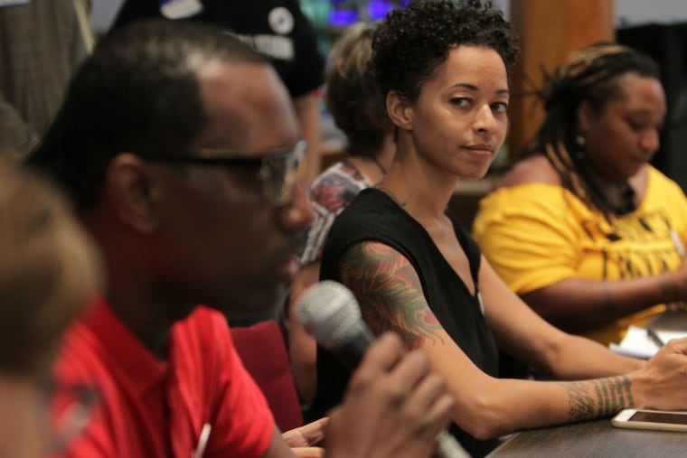 Brianna Jones, right, listens as Asa Khalif, of Black Lives Matter, speaks as local protest leaders hold a meeting to finalize plans for the DNC convention. The event was held at the Arch Street Methodist Church in Philadelphia, PA on July 20, 2016.