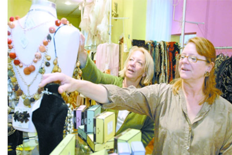 Philadelphia's proposed 8 percent sales tax worries retailers, such as Georgia Doyle (left) and Lisa Howe of Artisans on the Avenue, who operate near suburbs. (Ron Tarver / Staff Photographer)