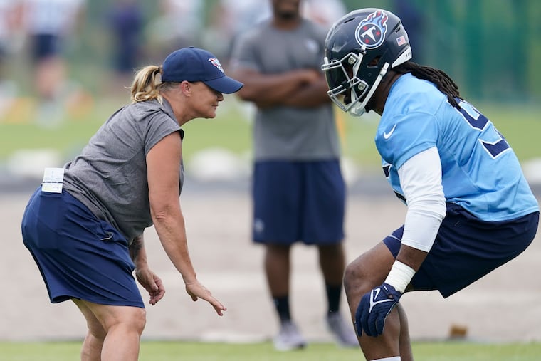 Lori Locust (left) works with defensive tackle Denico Autry at practice in 2023. Since then, she has been promoted within the Titans organization.