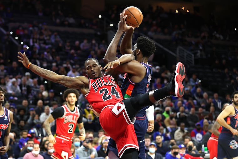 Joel Embiid secures the ball against Javonte Green in the first half..