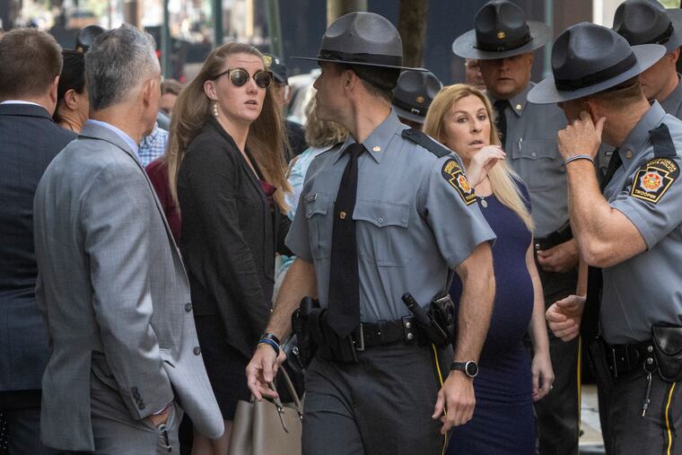 At left is Stephanie Mack, wife of Trooper Martin F. Mack III, and right, Brittany Sisca, wife of Trooper Branden T. Sisca as they arrive for preliminary hearing for Jayana Webb.