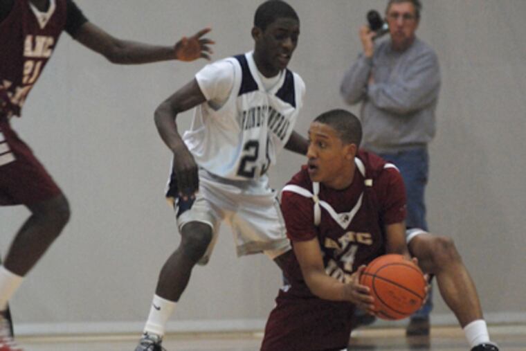 Jonathan Riles of Academy of the New Church, right, recovers from a fall as Justin Pinder of Friends Central guards him in the Friends Schools League Championship game at Haverford College. (Amanda Cegielski / Staff Photographer )