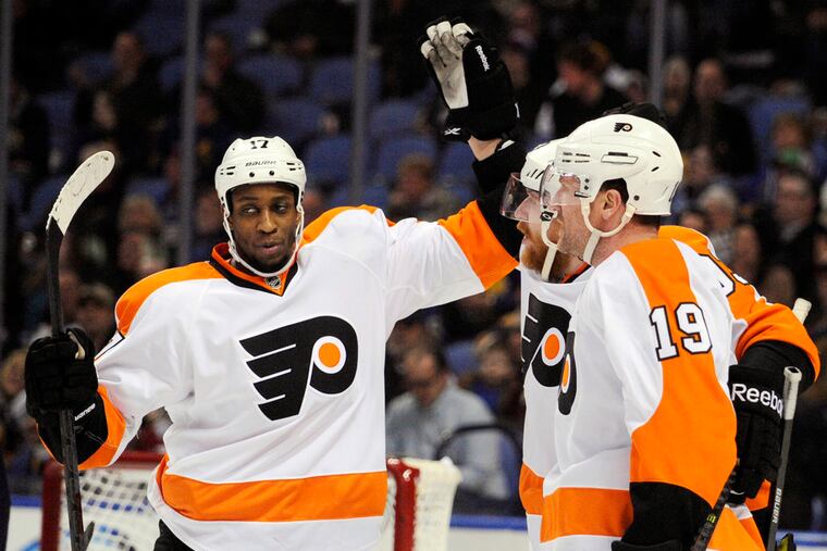Philadelphia Flyers' Wayne Simmonds, left celebrates with Jakub Voracek , center, and Scott Hartnell, right, celebrate after a goal by Voracek during the second period of an NHL hockey game against the Buffalo Sabres in Buffalo, N.Y., Tuesday, Jan. 14, 2014. (AP Photo/Gary Wiepert)