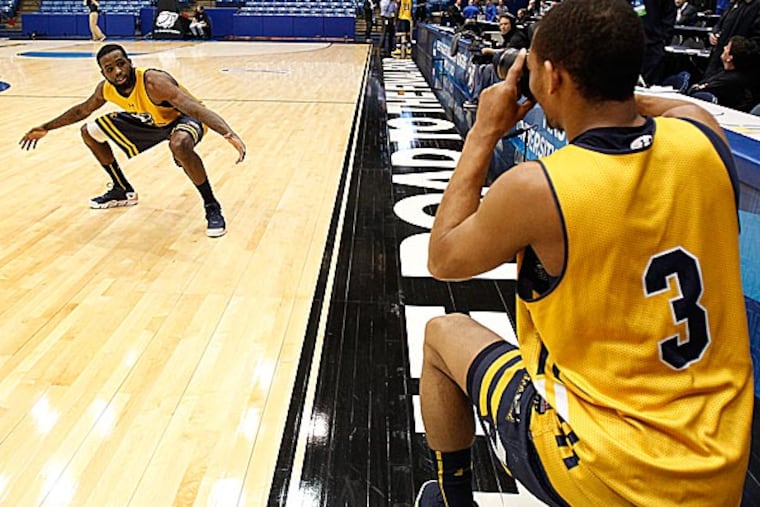 Guards Ramon Galloway (left) and Tyreek Duren do a mock photo shoot on the court. (David Maialetti/Staff Photographer)