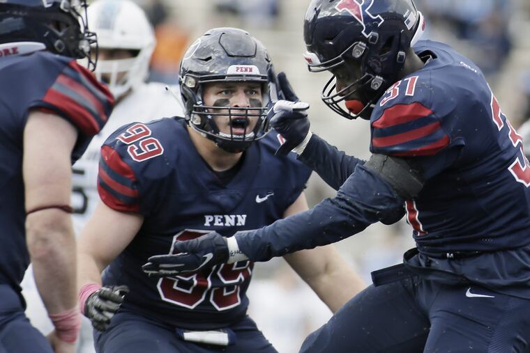 Penn 99 Cooper Gardner looks to teammate # 31 Benji Mowatt who celebrates after sacking Columbia quarterback Josh Bean with under 2 minutes to go in the Columbia at University of Penn football game at Franklin Field in Phila., Pa. on October 13, 2018. Penn won the game 13-10. ELIZABETH ROBERTSON / Staff Photographer