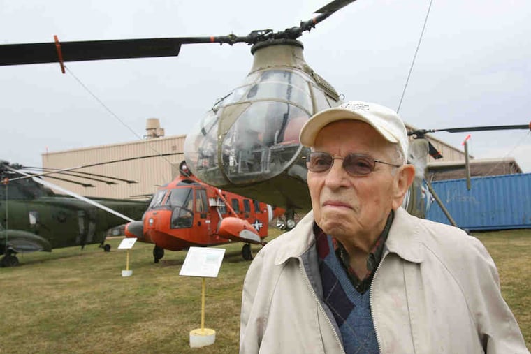At the American Helicopter Museum in West Chester, Mack stands in front of a CH-21C Shawnee by Piasecki; he suggested extending the windshield lower for increased visibility. Left, Mack works on restoring the control panel for a Piasecki HUP-2 at the museum shop. He worked as a machin- ist, designer, and engineer for several aircraft companies.
