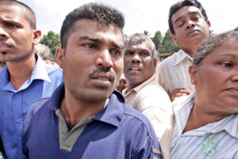 Relatives of victims near the site of the explosion. More than 90 people were wounded in the attack blamed on Tamil Tiger rebels.
