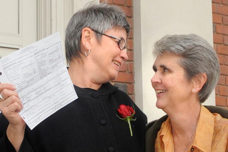 Jody Mock (left) and Beth Kerrigan, both of West Hartford, Conn., share a moment at town hall after receiving their marriage license.