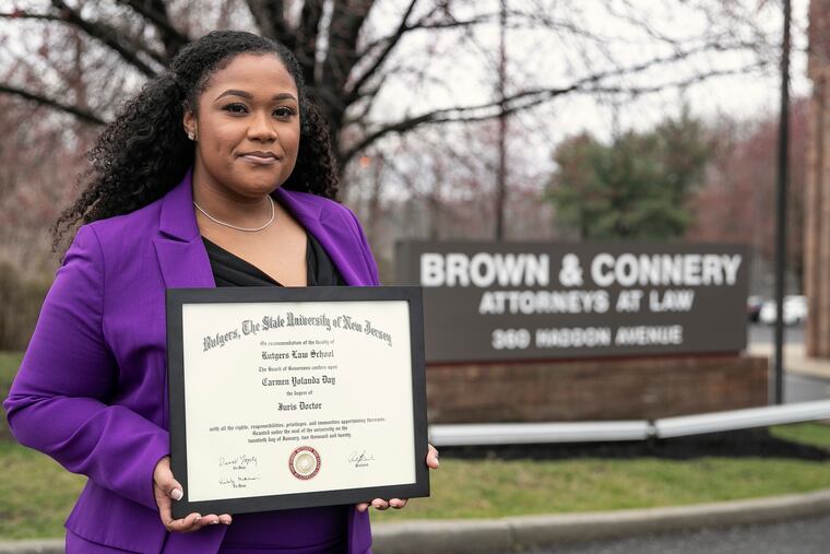 Carmen Day poses for a portrait with her diploma from Rutgers Camden Law in front of the law offices of Brown & Connery in Collingswood. Day is a former juvenile delinquent who turned her life around and went to Rutgers Camden law school after a judge gave her a second chance. She now works at the law firm in South Jersey.