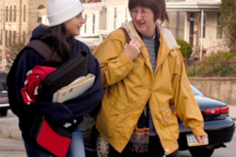 Fawn Vrazo walks with daughter Anna. They were headed for a drive to Anna's school on Nov. 16, 2004. Vrazo was waiting for a blood test, then a meeting with her doctor, before chemotherapy.
