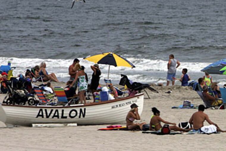 Beachgoers in Ocean City were told to stay above the water line today. Syringes have been found there and in Avalon, Sea Isle City and Strathmere. (Laurence Kesterson / Inquirer)