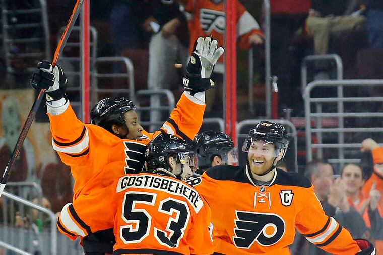 Wayne Simmonds (left) celebrating one of the 204 goals he scored as a Flyer with teammates Shayne Gostisbehere and Claude Giroux. He plays now for his hometown Maple Leafs.