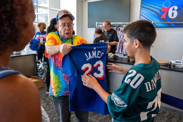 Noah Hammad, 12, wears the jersey of one Philly great while shopping for merchandise of the city's newest superstar, LeBron James.