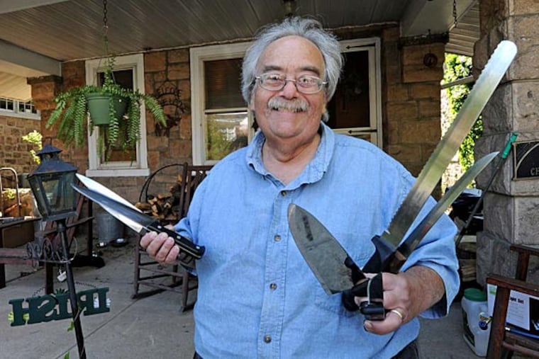 Neil Jacob sharpens the dullest knives, shears, scissors, and axes, then hands them back to their owners with a word of caution: "I tell them, 'Don't run with it.' " (April Saul/Staff)