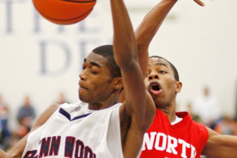 Penn Wood's Duane Johnson (left) wins the rebound in a duel with North Catholic's Jaleel Mack. Johnson scored 8 points.