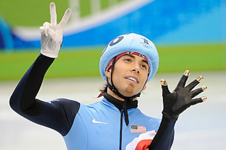 Apolo Ohno holds up seven fingers to signify his seven medals, the most in U.S. Winter Olympics history. (Clem Murray/Staff Photographer)