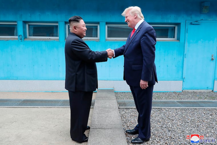 In this Sunday, June 30, 2019, photo provided by the North Korean government, North Korean leader Kim Jong Un, left, and U.S. President Donald Trump shake hands over the military demarcation line at the border village of Panmunjom in Demilitarized Zone. The content of this image is as provided and cannot be independently verified. Korean language watermark on image as provided by source reads: "KCNA" which is the abbreviation for Korean Central News Agency. (Korean Central News Agency/Korea News Service via AP)