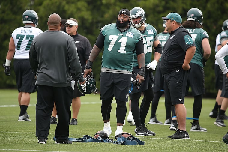Jason Peters talks to his coaches during practice.