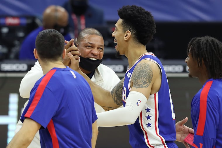 Sixers coach Doc Rivers celebrates with Danny Green of the SIxers after he hit a 3-pointer in the second half to force the Raptors to call a timeout.