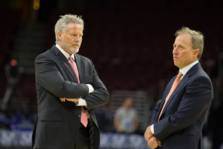 Sixers managing partner Josh Harris, right, here with coach Brett Brown before a game last season, donated as part of The Philly Pledge.