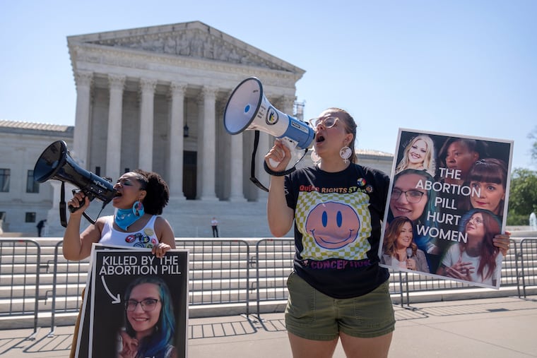 Anti-abortion protesters demonstrate outside the Supreme Court on June 13. The court unanimously preserved access to a medication that was used in nearly two-thirds of all abortions in the U.S. last year.