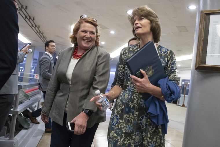 Democratic Sen. Heidi Heidkamp of North Dakota, seen here with Republican Sen. Lisa Murkowski of Alaska, announce she will vote "no" on Judge Brett Kavanaugh's Supreme Court nomination.