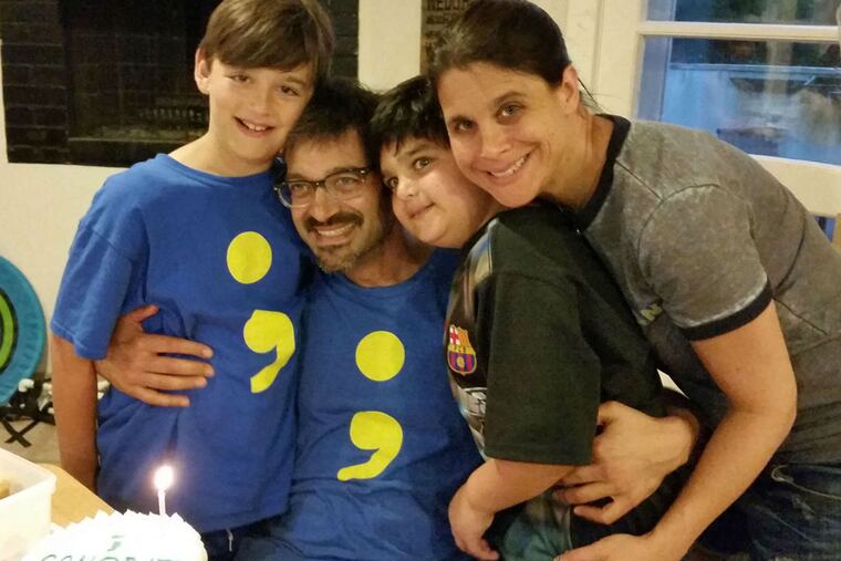 The Ross family (from left) - Jacob, Michael, Benjamin, and Wendy - and the shirt that bears a message of humor and hope.