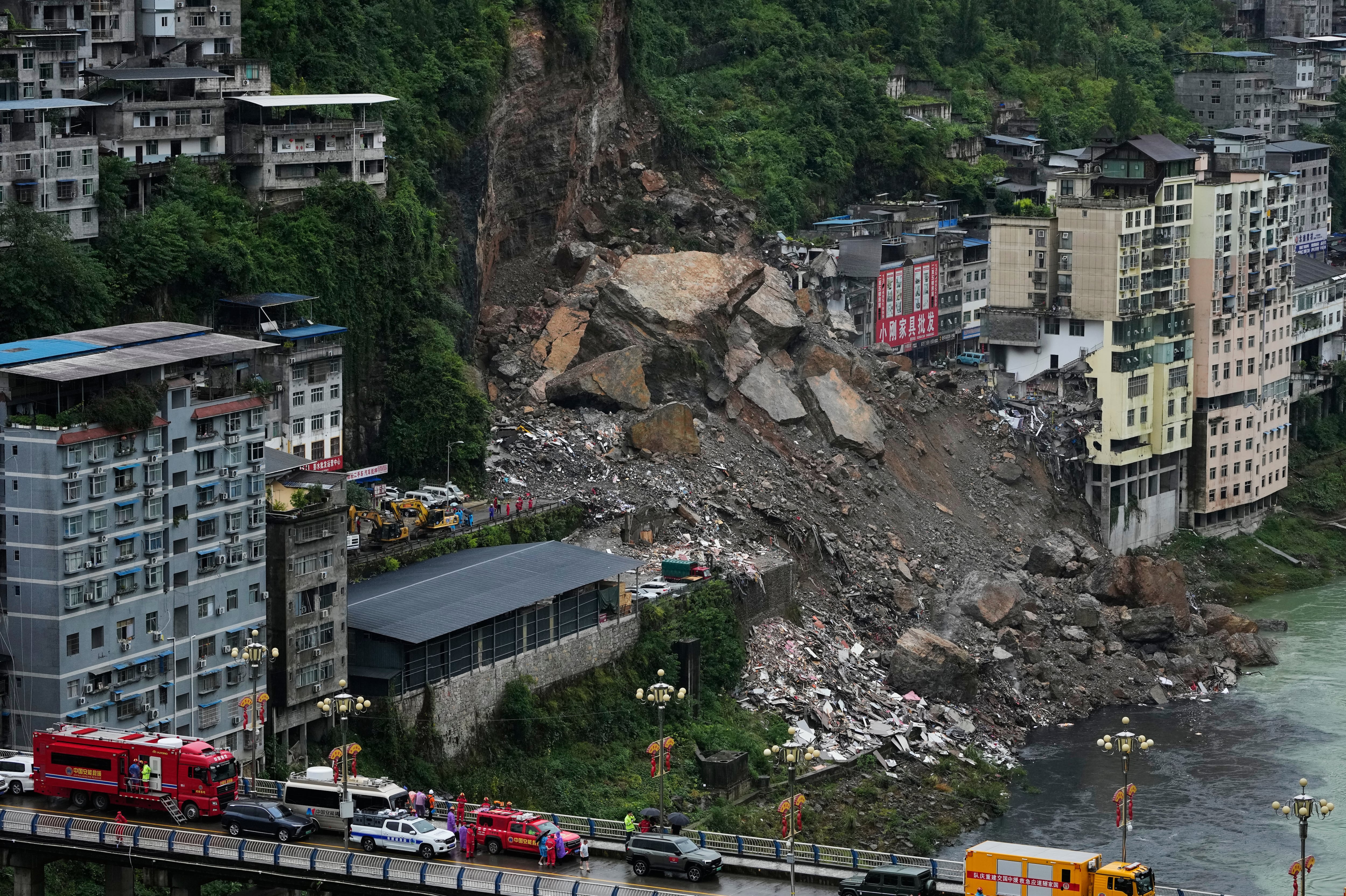Rescuers race to find survivors in the rain after a landslide in China kills at least 8