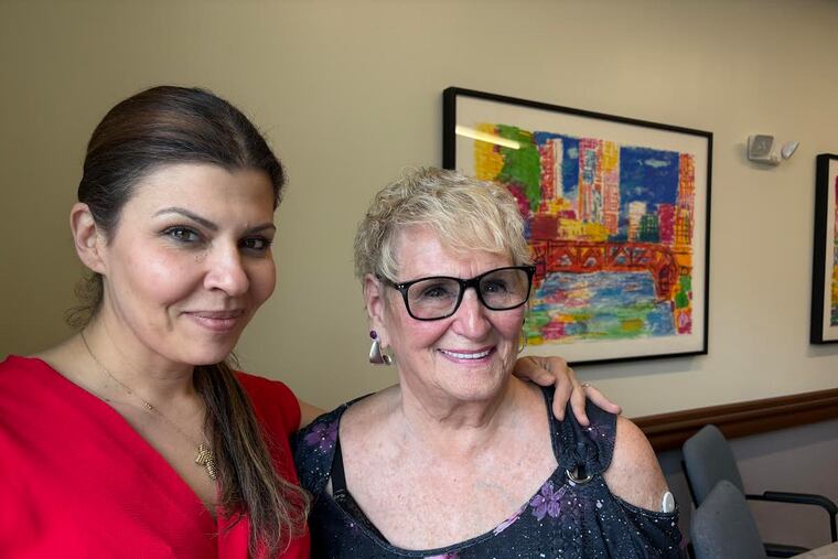 Rachel Nassif, day center director at the PACE Organization of Rhode Island, with program participant Roberta Rabinovitz. Rabinovitz goes to the center, in East Providence, for all her medical care, and an occasional lunch. PACE also set her up with a studio apartment in an assisted living facility in Bristol. (Felice J. Freyer for KFF Health News)