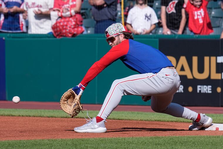 Bryce Harper warms up at first base before a game Friday against the Cleveland Guardians.