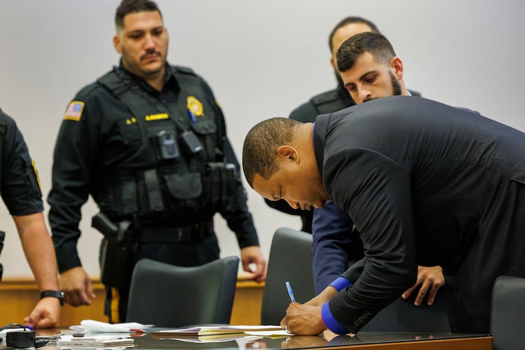 Atlantic City Mayor Marty Small signing a form before leaving the courtroom after his arraignment before Judge Bernard DeLury in Mays Landing, N.J. on Oct. 10, 2024.